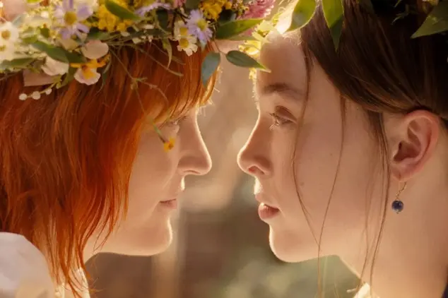 Ella Beatty as Lizzie Borden and Vicky Krieps as housekeeper Bridget "Maggie" Sullivan sharing an intimate moment wearing flower crowns in Ryan Murphy's Netflix series Monster: The Lizzie Borden Story.